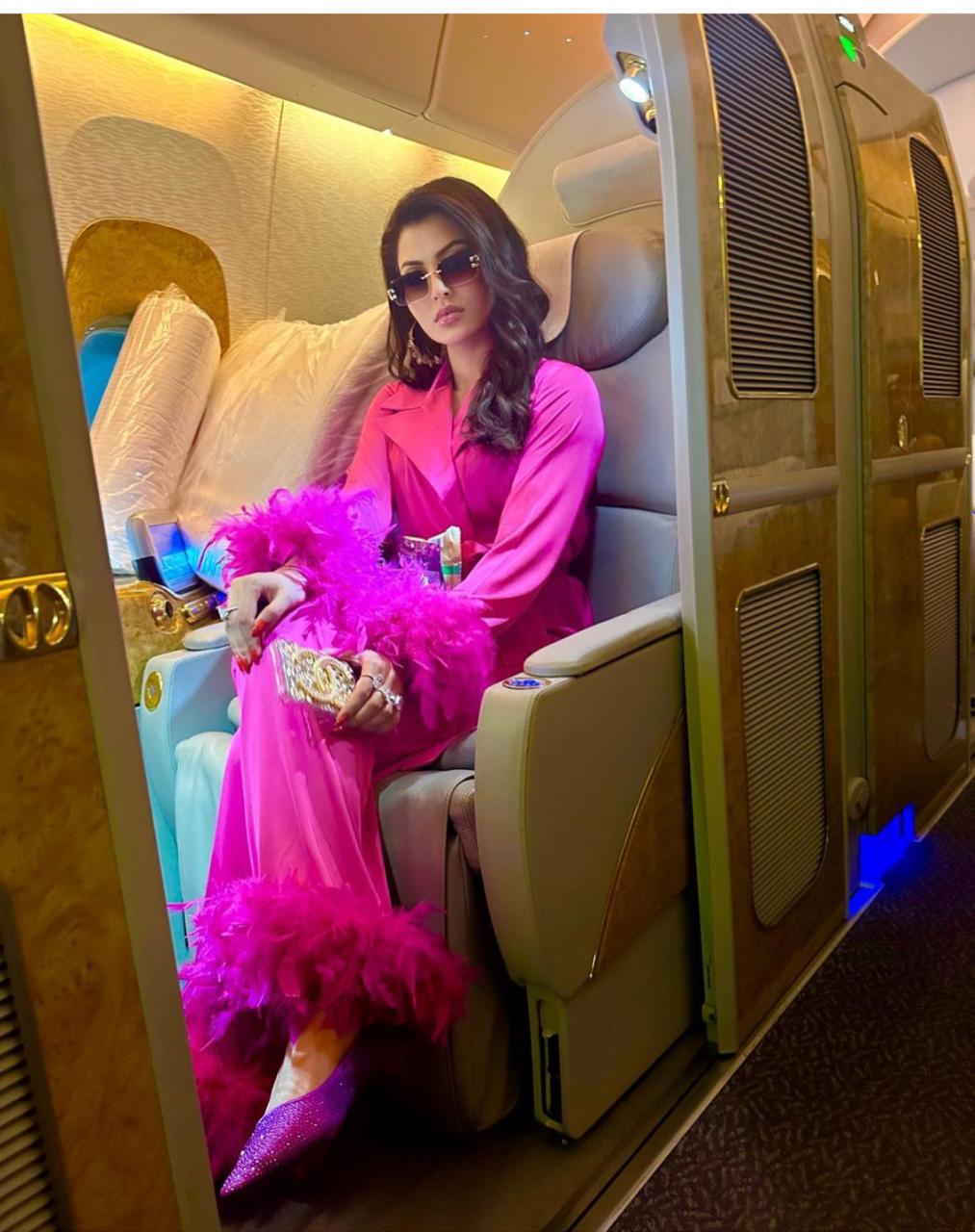 Urvashi Rautela Turns Heads with Luxurious Airport Look in Pink Satin Feather Suit